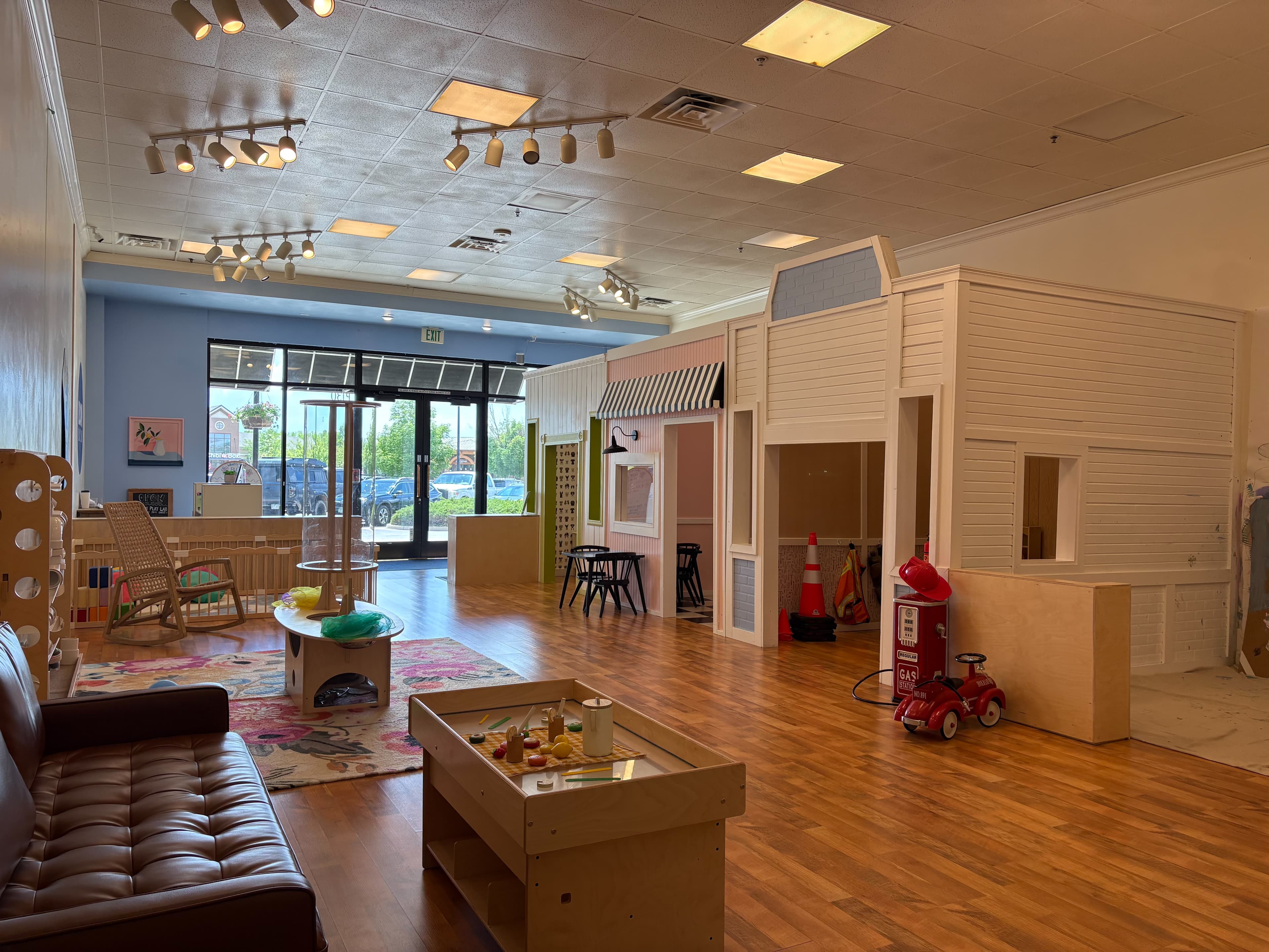 Bright indoor play space at Bloom Play Lab in Loveland with playhouses and activity areas